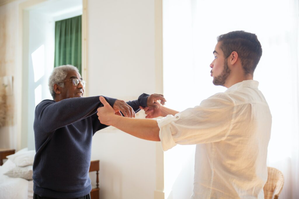 personal care services from a young man helping an older man